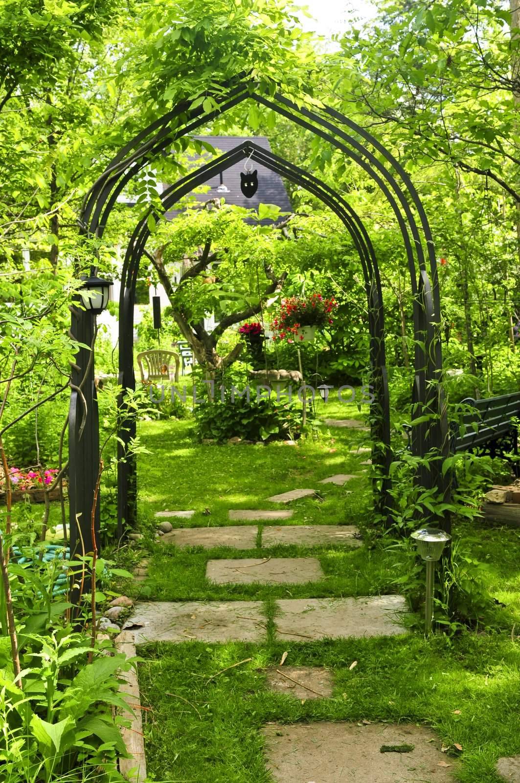 Lush green garden with wrought iron arbor