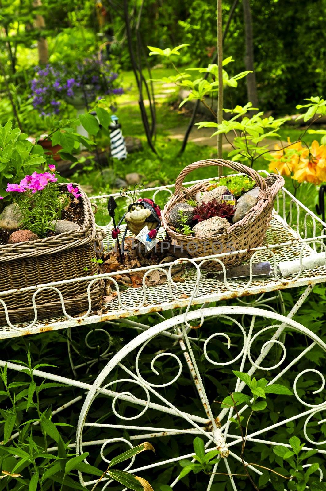 Flower cart with two baskets in summer garden