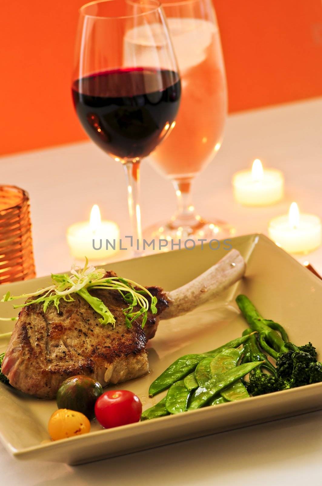 Gourmet romantic dinner with red wine at candlelight