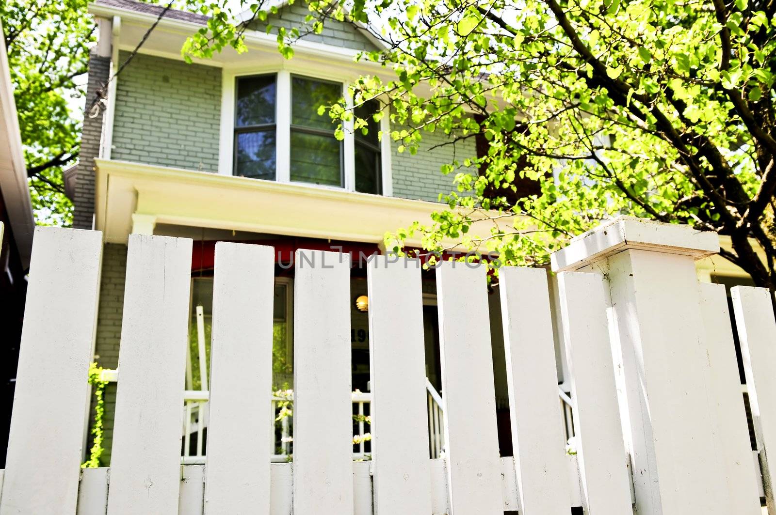 White fence around front yard of residential house