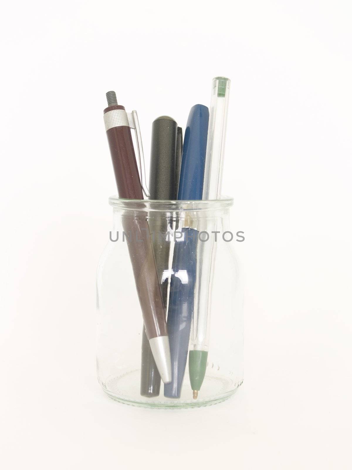glass bottle and pens