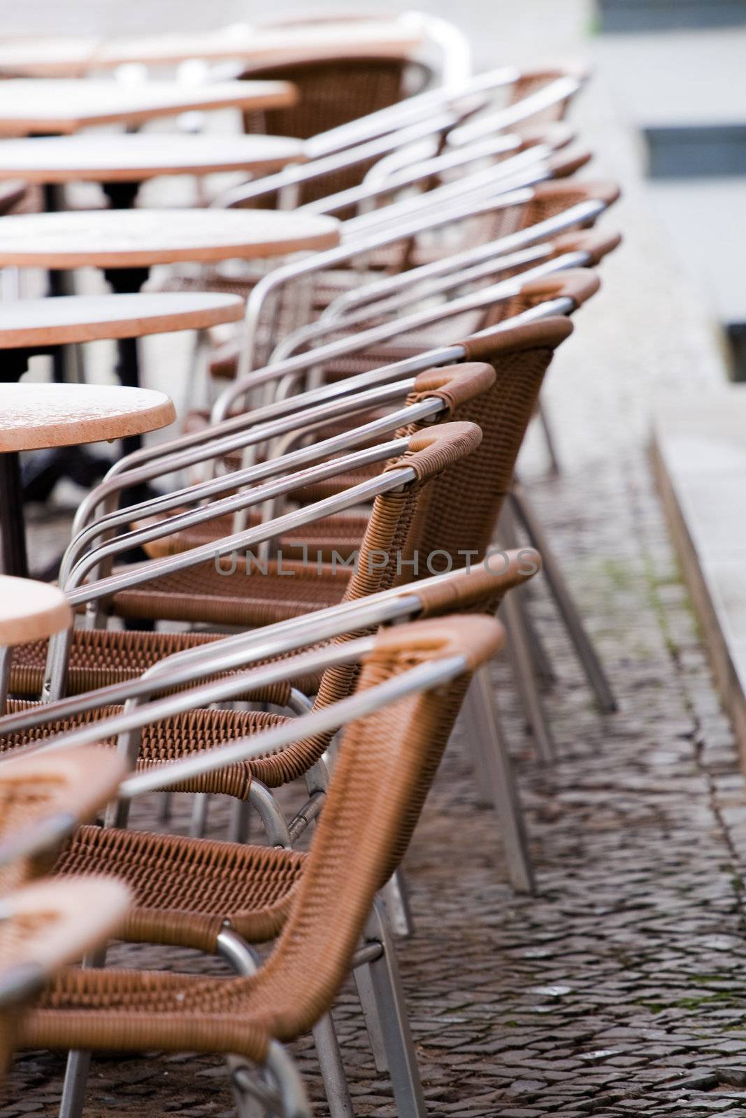 Outdoor cafe chairs and tables on a rainy day