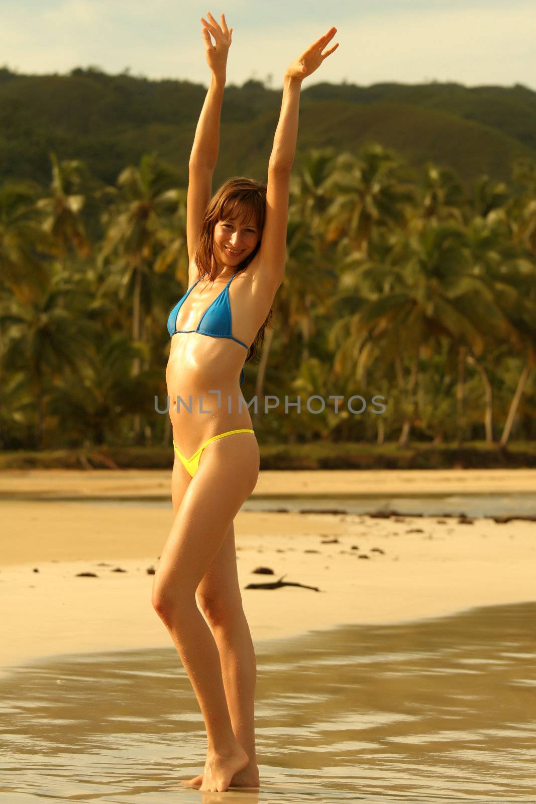 happy bikini girl posing on the beach