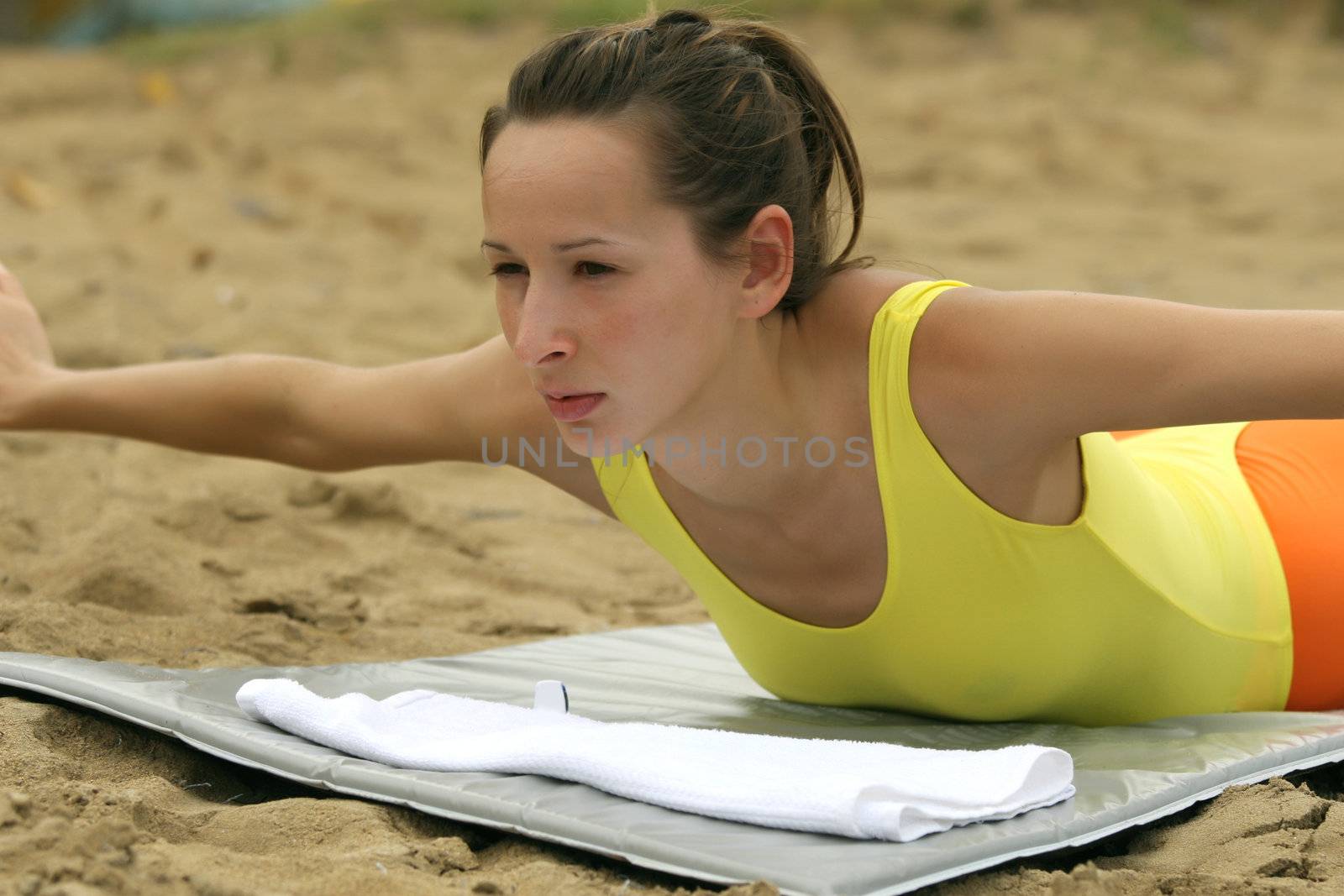 Woman in yellow leotard doing stretching exercises