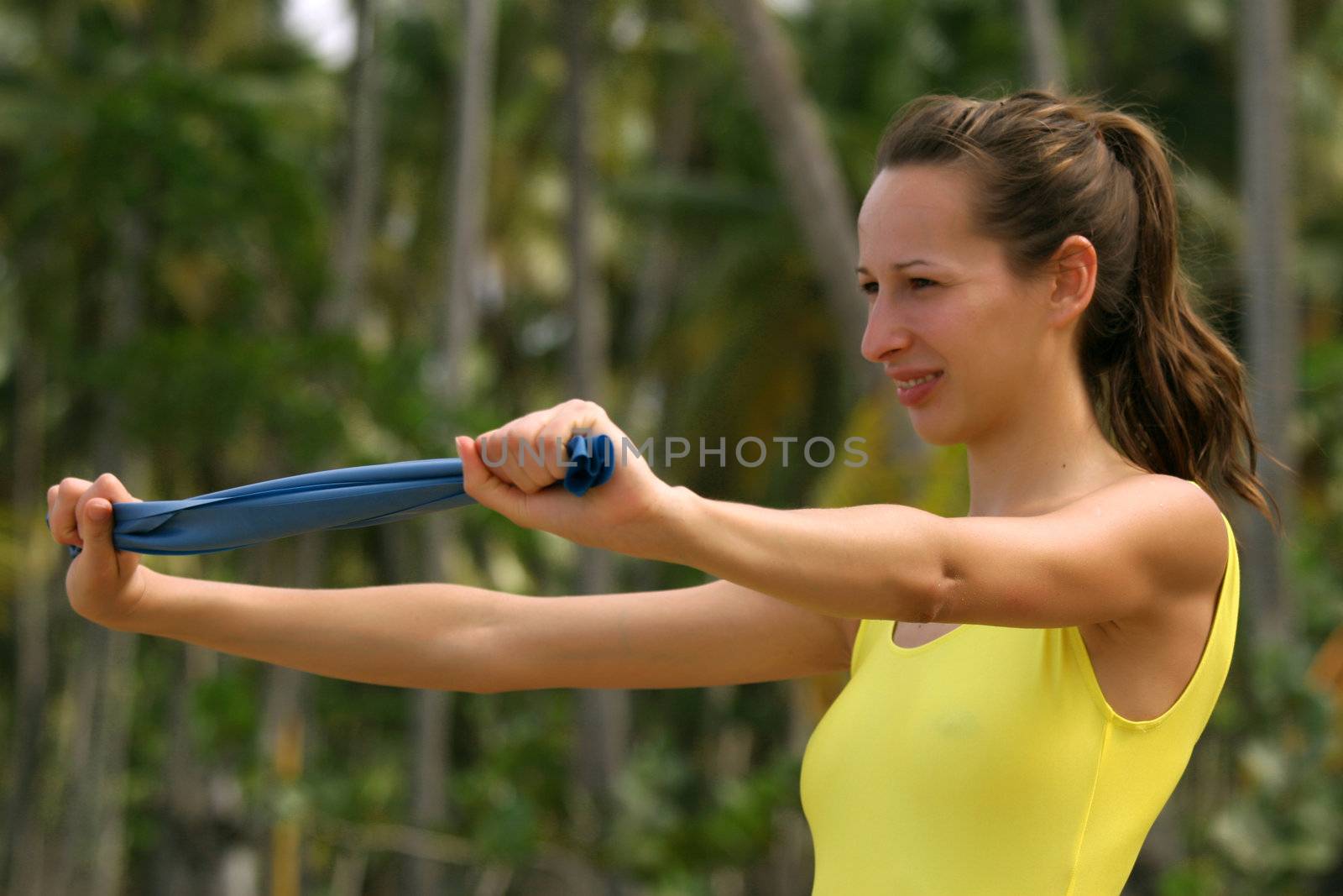 Woman in yellow leotard doing stretching exercises