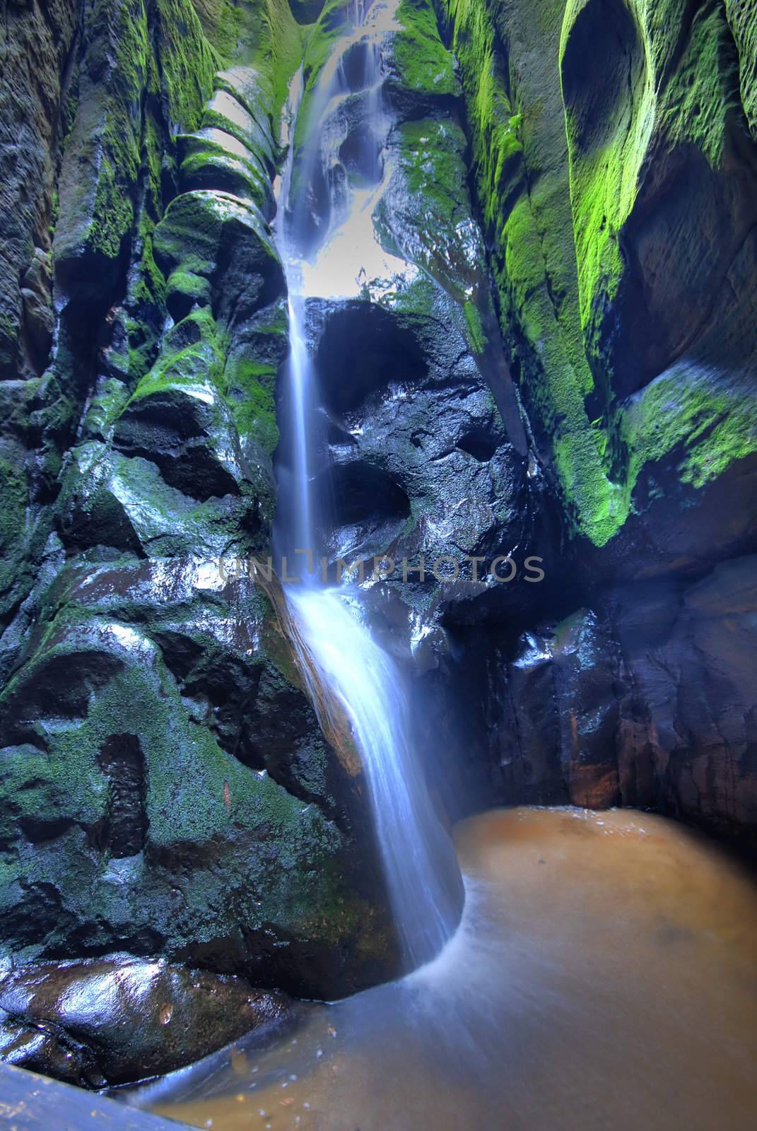 Waterfall in Aderspach sandstone rock city in Czech Republic