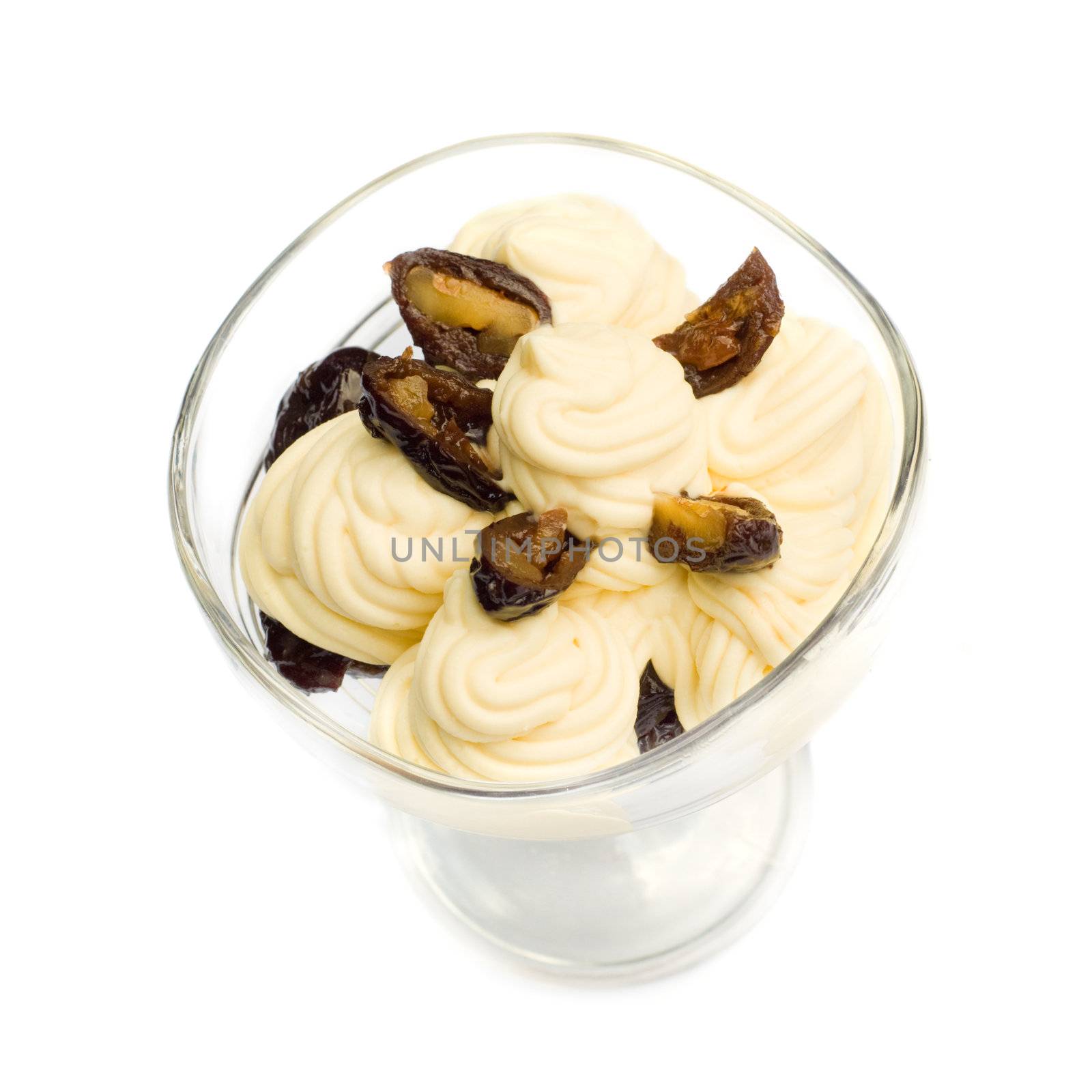 prunes stuffed with walnuts and almonds, in sweet cream, isolated on white