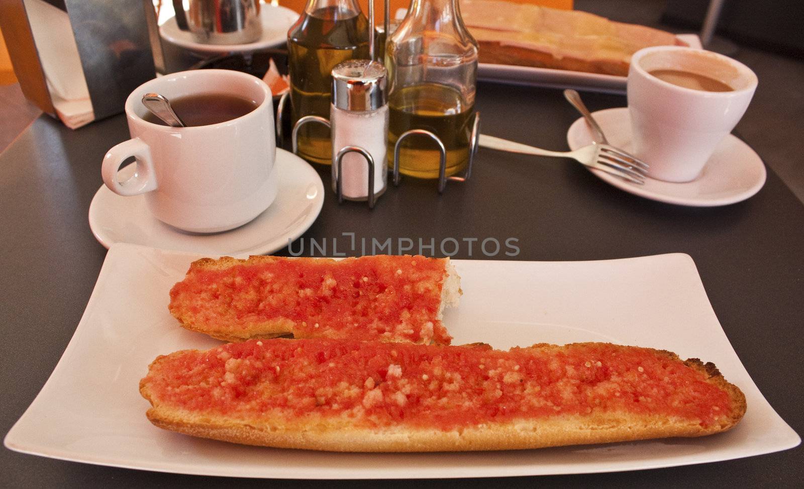 Breakfast in a cafeteria in Mediterranean Spain: tomato toast and coffee.