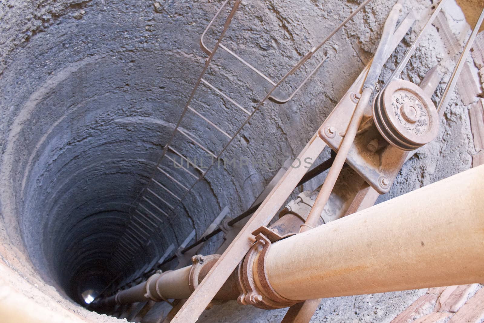 Well used for irrigation showing ladder, mechanism and pipe.