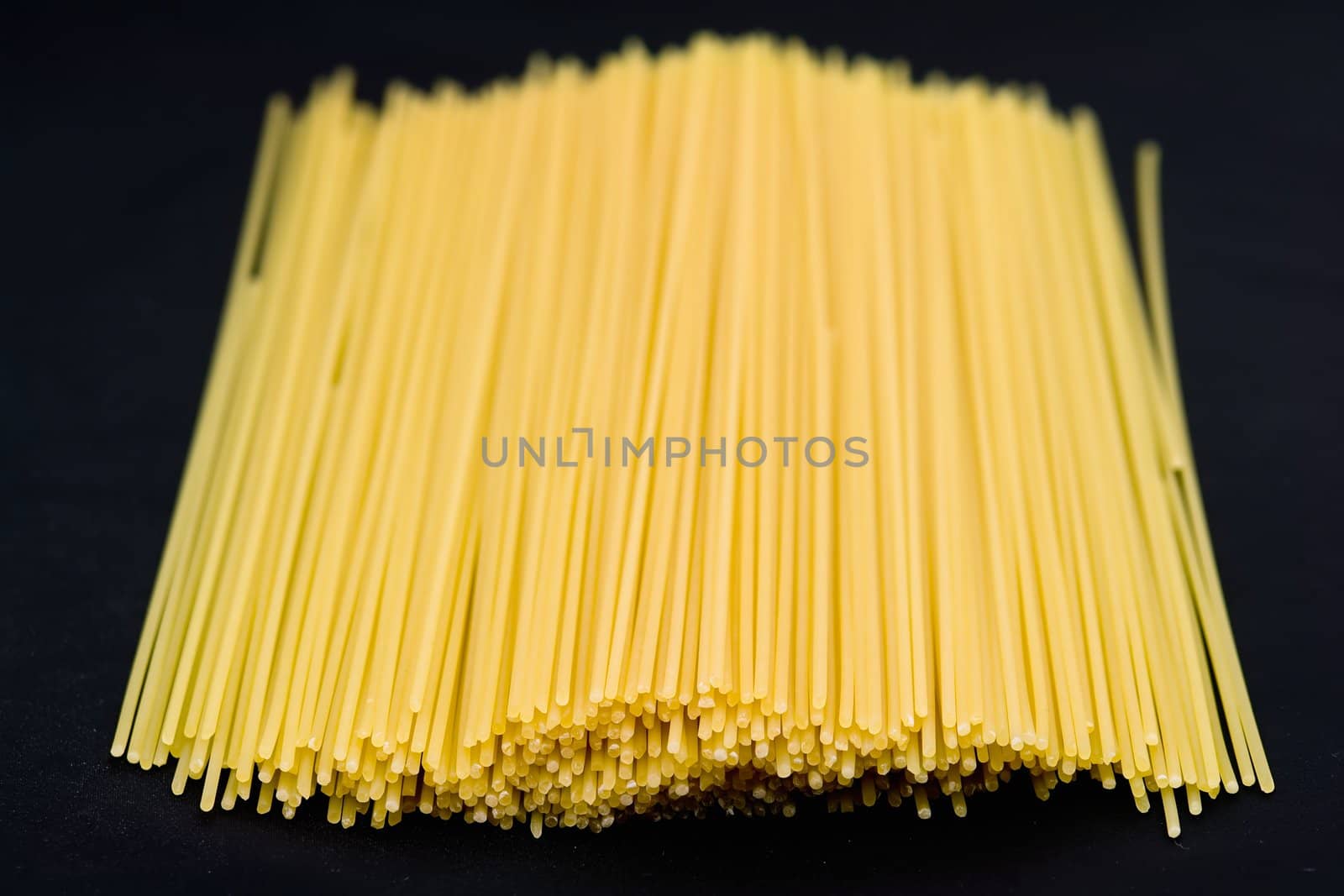 Macaroni background. Yellow spaghetti close up.
