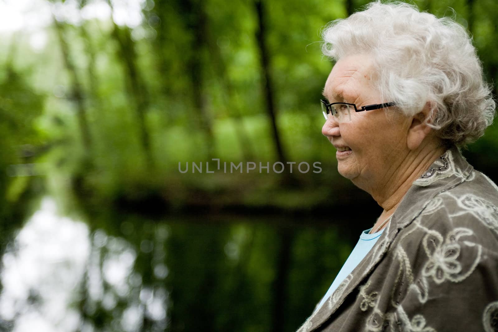 outside portrait of an elderly woman overlooking a stream