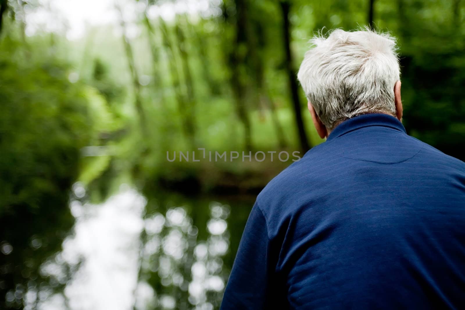 outside portrait of a man looking over water