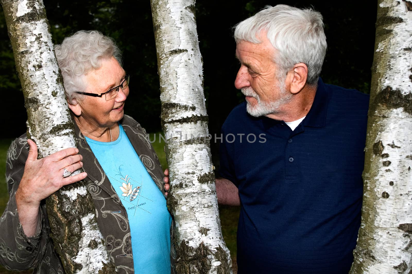 outside portrait of an elderly couple looking at eachother