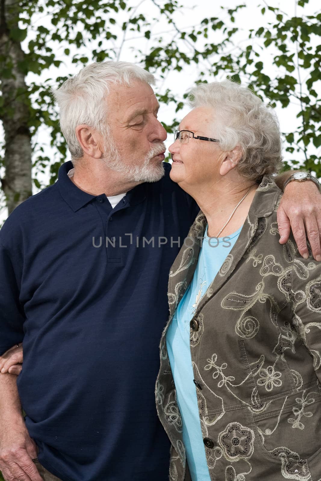 outside portrait of an elderly couple loving