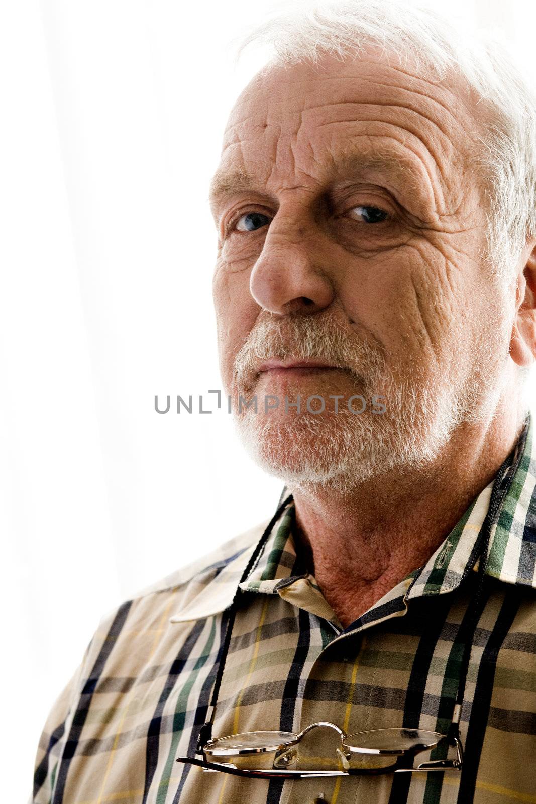 portrait of an elderly man in bright white licht