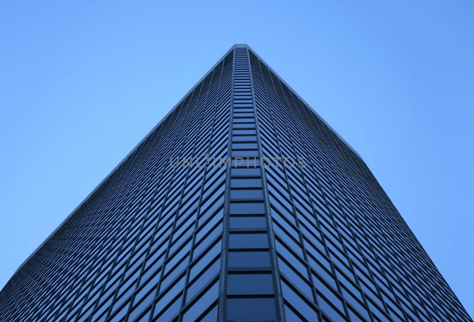 Angle view of a glass-windowed corporate tower.