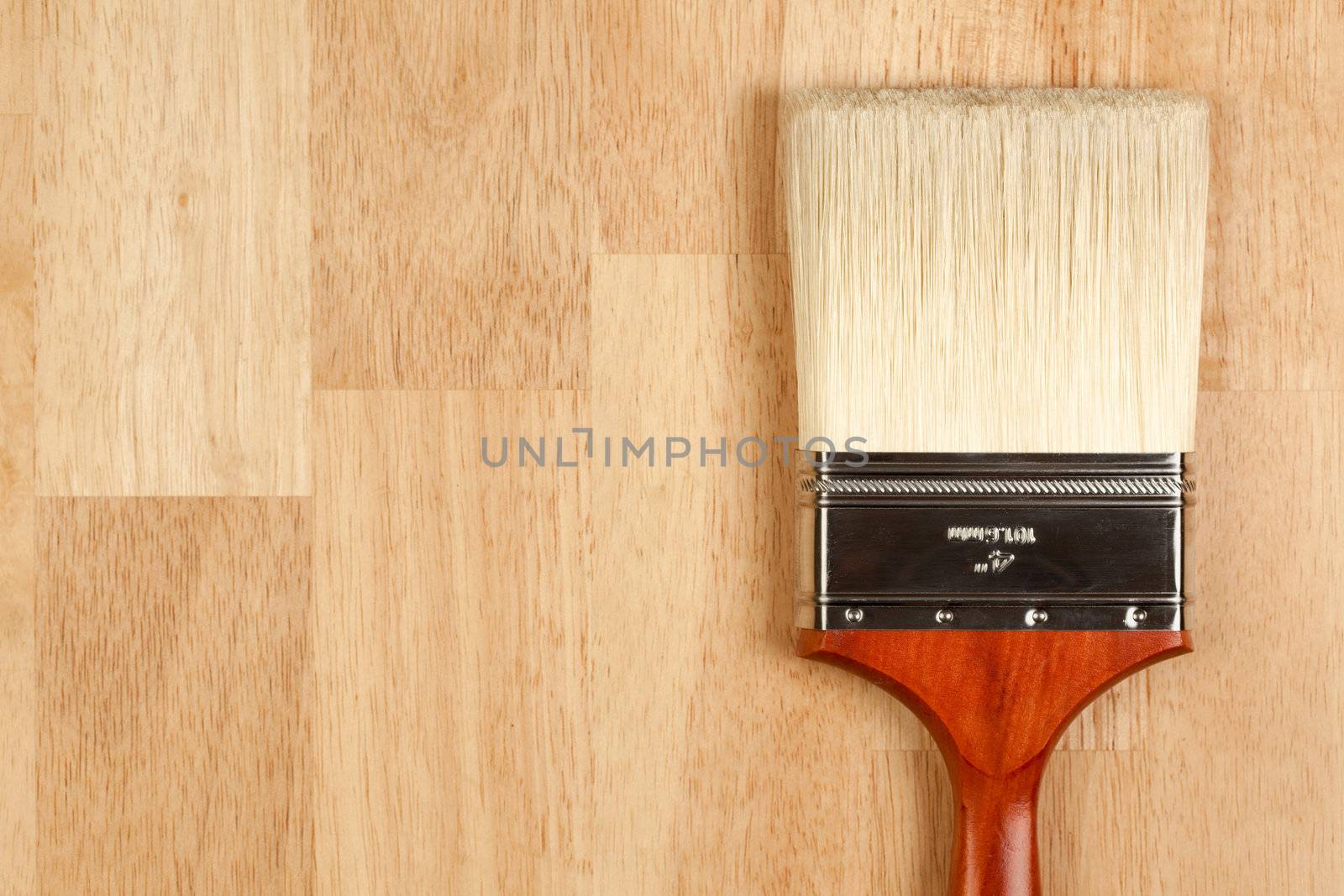 Paint Brush on a Wood Surface with Copy Room.