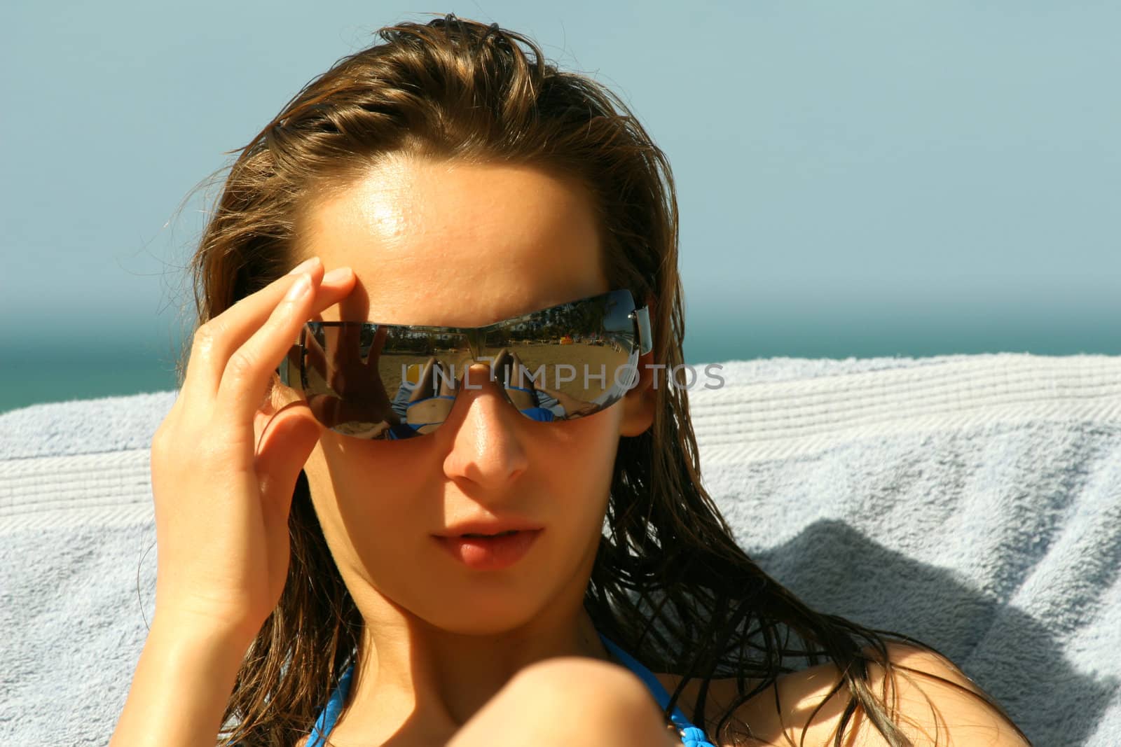 Woman in sunglasses by the pool