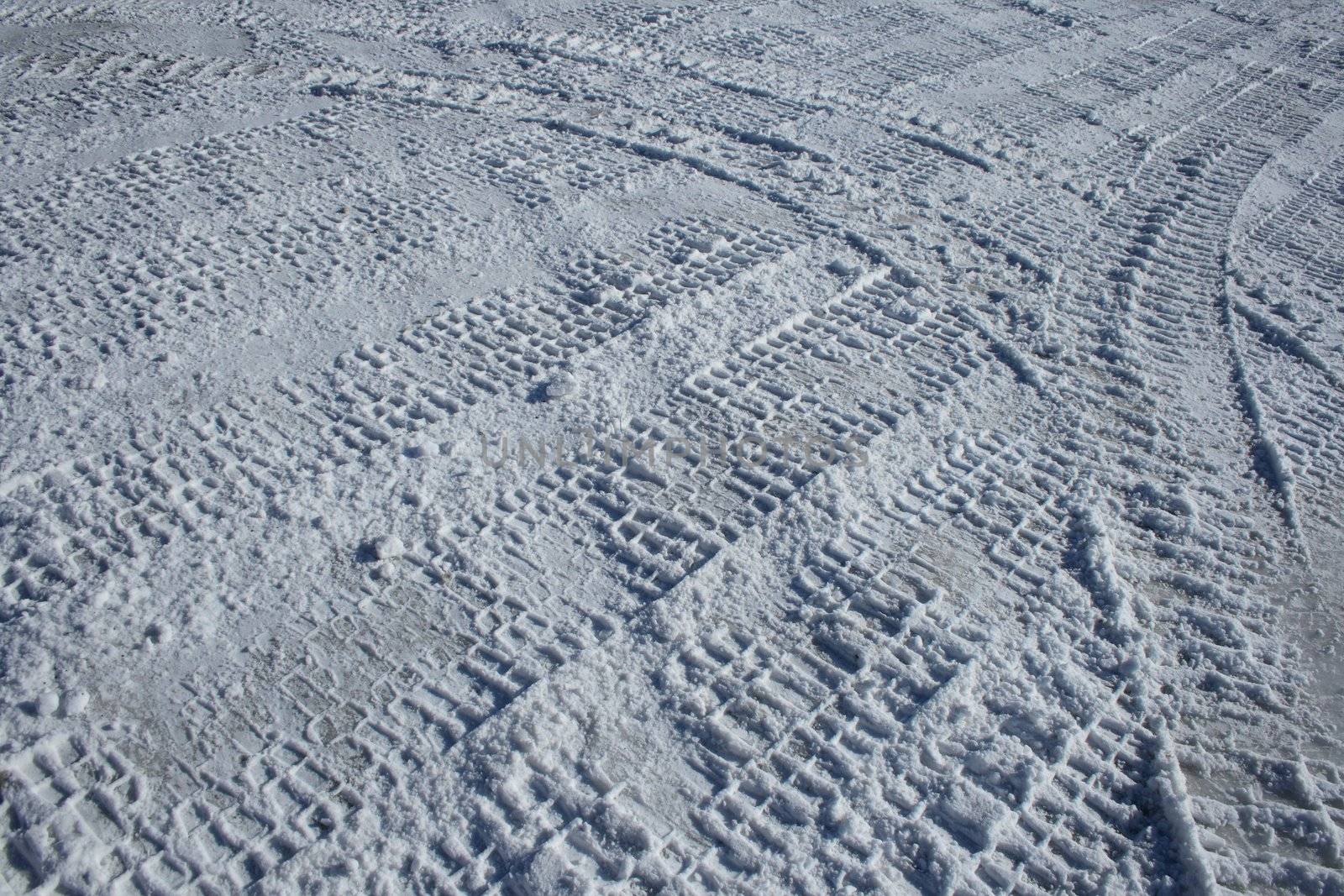 Vehicle tracks crossing the snowy terrain by anikasalsera