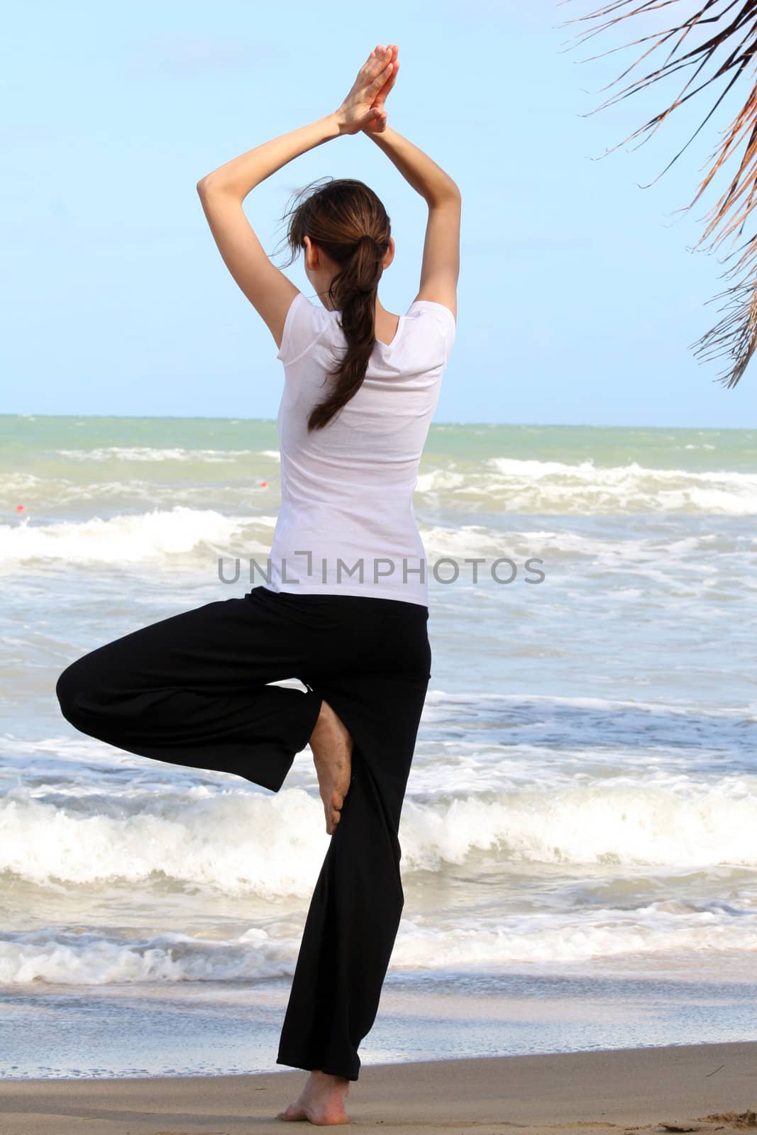 Yoga exercises on the beach in the caribbean