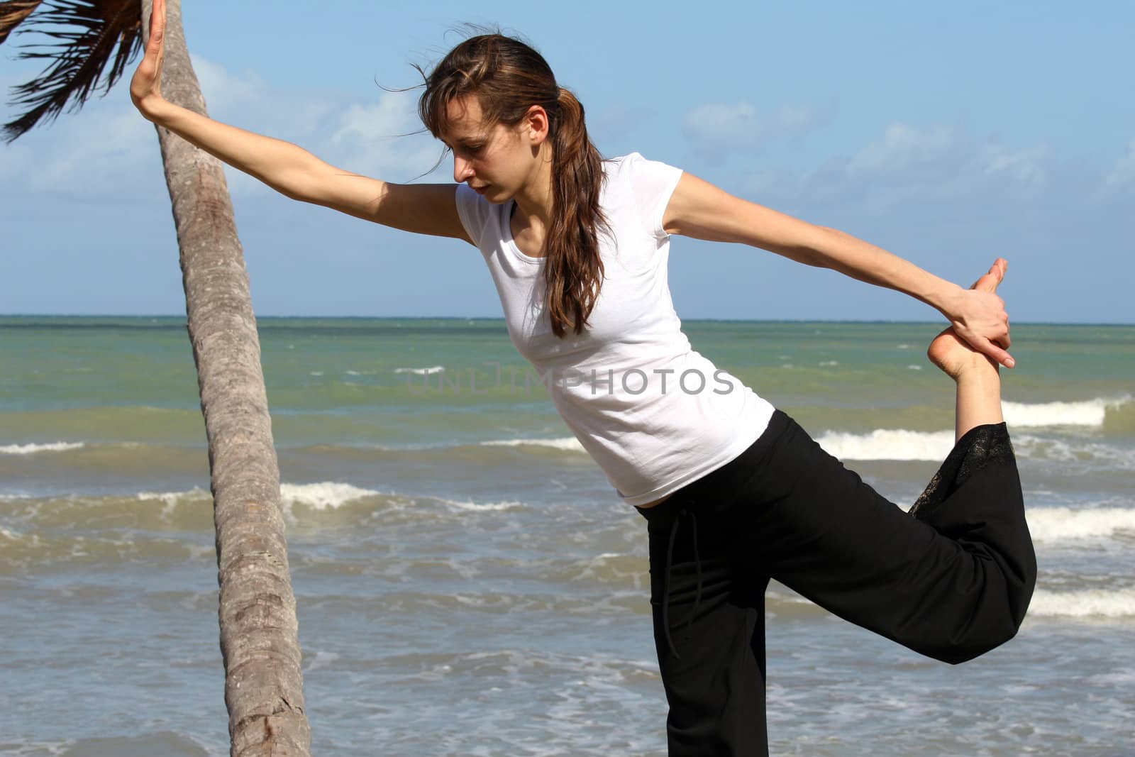 stretching and balancing exercise on the beach