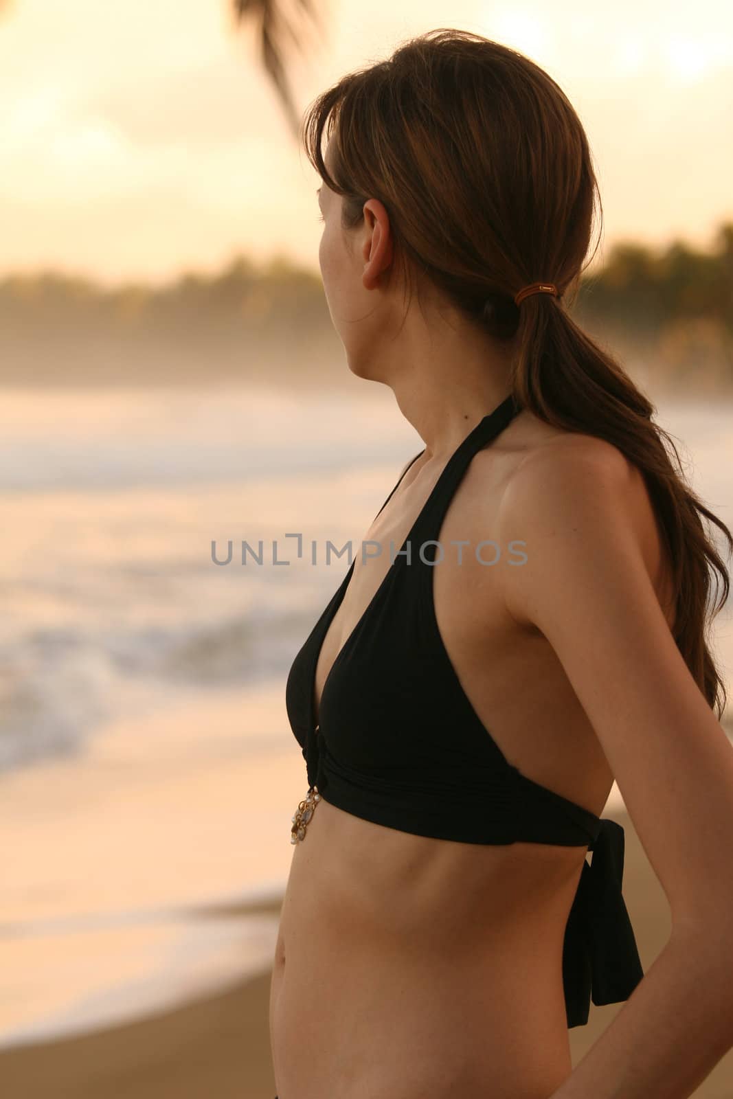 Woman relaxing after workout on the beach