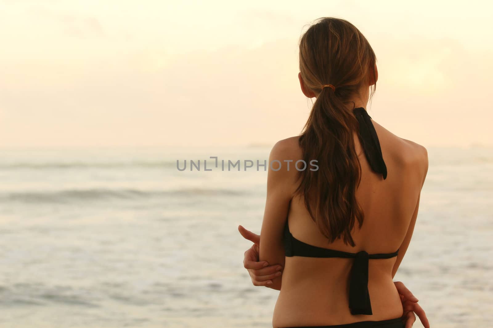 woman on the beach by sunset after workout