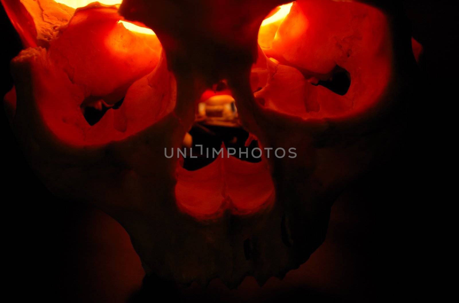 Front of burning skull - old skull against black background with inner flame