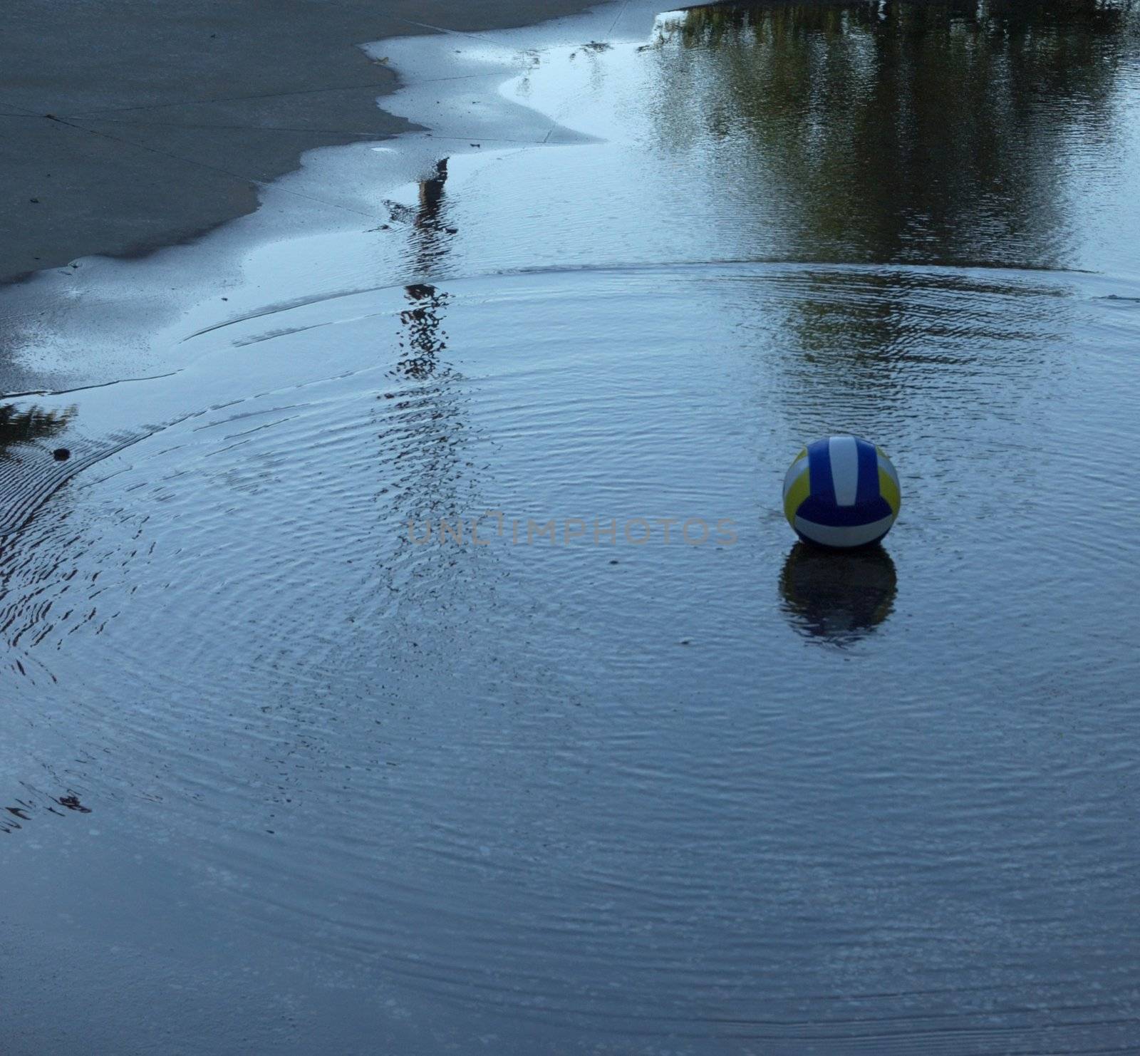 Where is my childhood? Ball lying in the puddle after rain