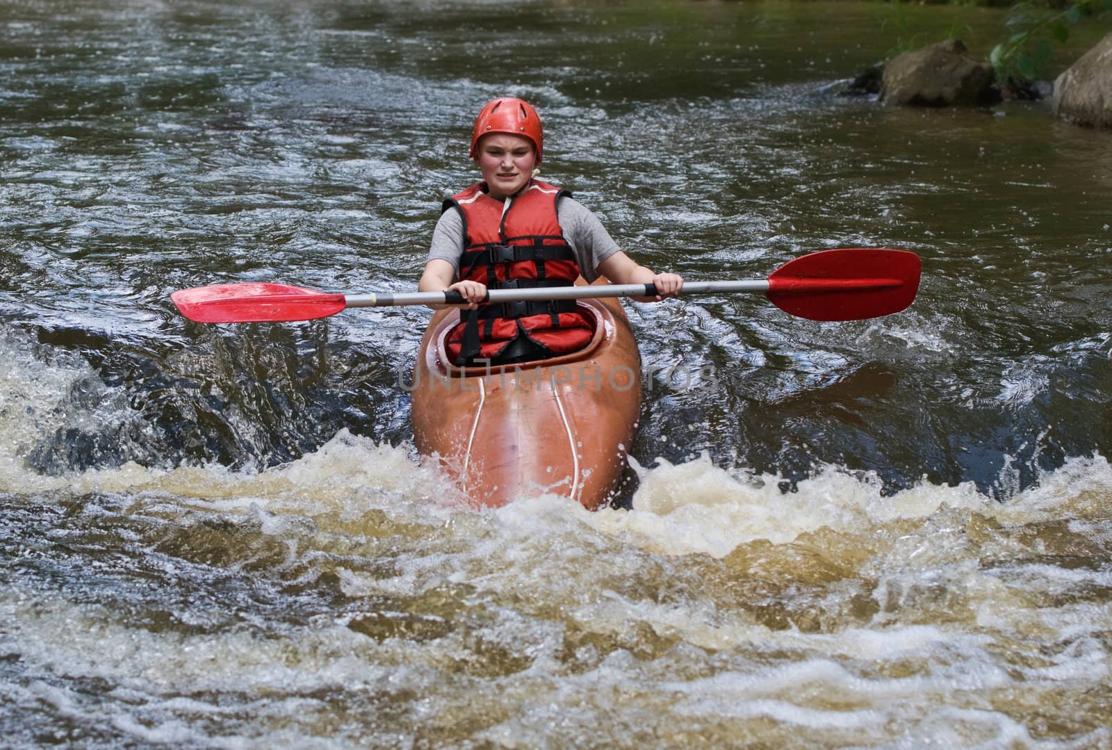 teenage girl white water kayaking by clearviewstock