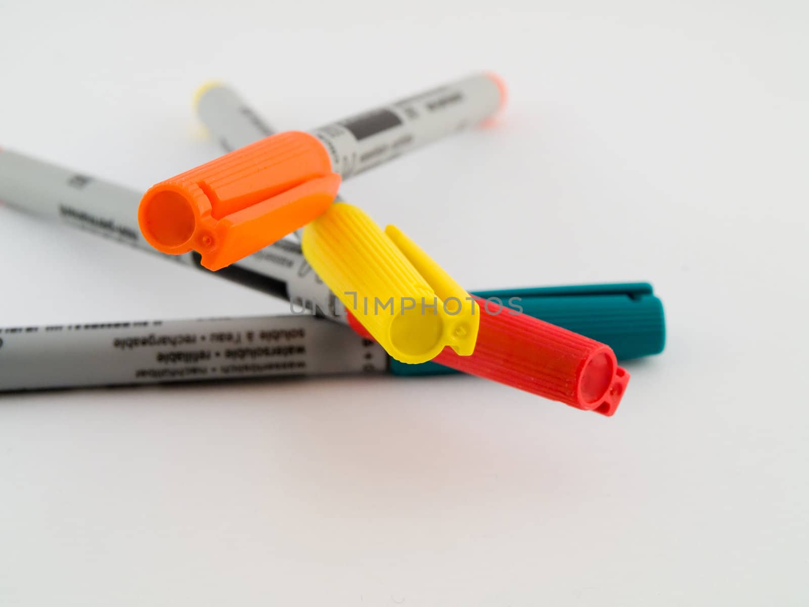 Ultra Fine Tipped Office Marker Pens on White Background in Red Orange Green and Yellow