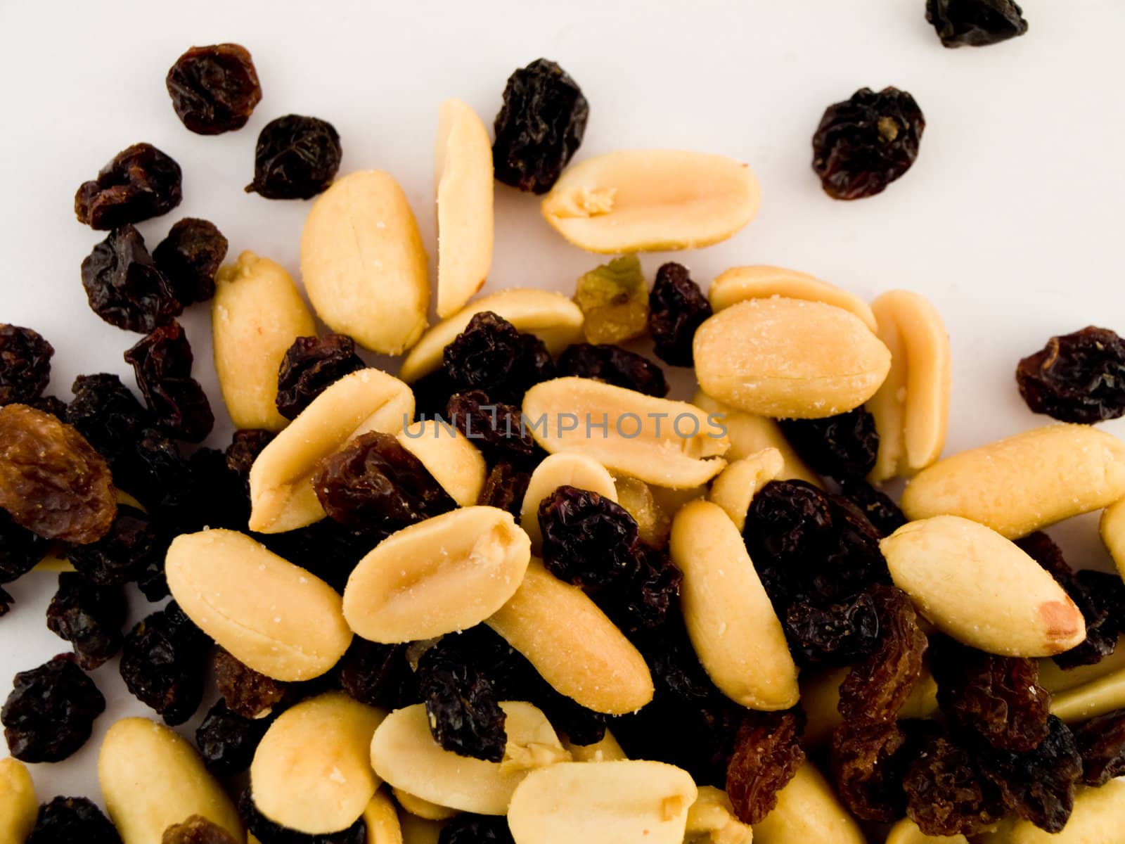 Stack Pile of Peanuts and Raisins on White Background by bobbigmac