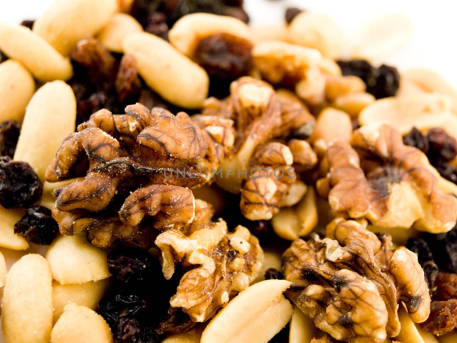 Close Up Walnuts Peanuts and Dried Fruit on White Background by bobbigmac