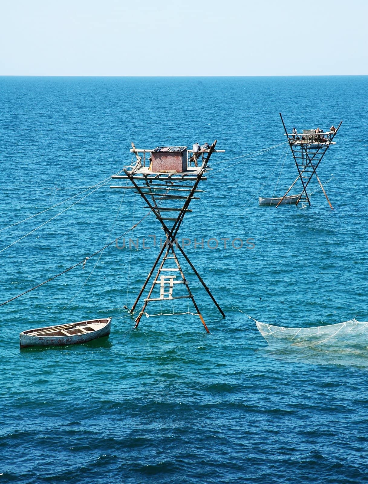 Fisherman�s towers and nets on the bright blue sea.