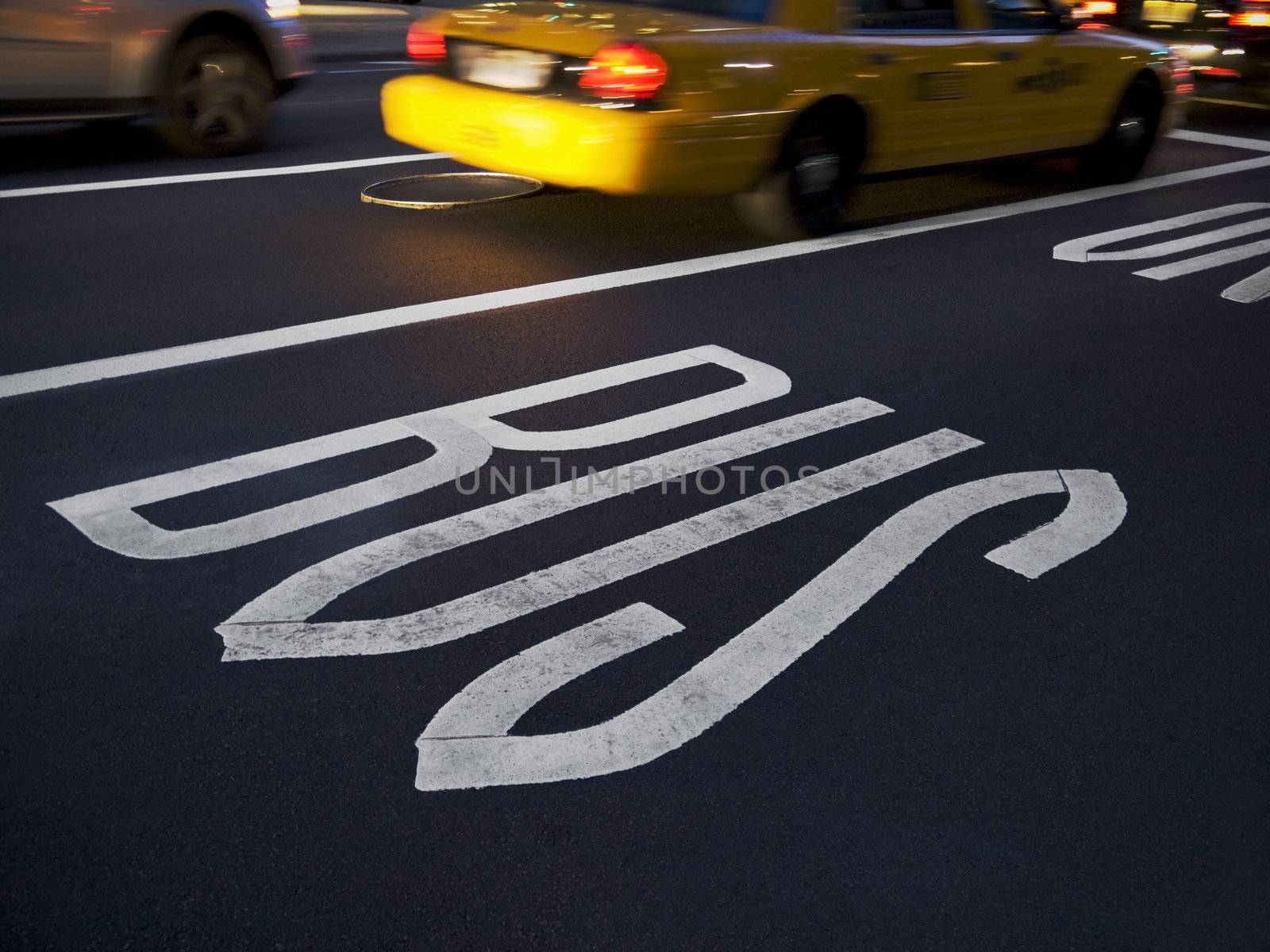 A New York cab running beside the bus lane. Motion blur.