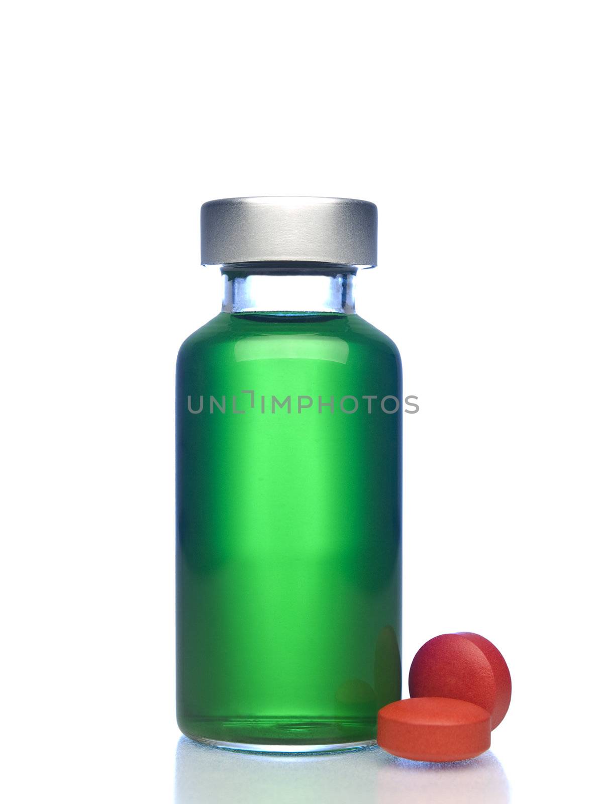 Isolated vial full of green liquid, red pills aside.
