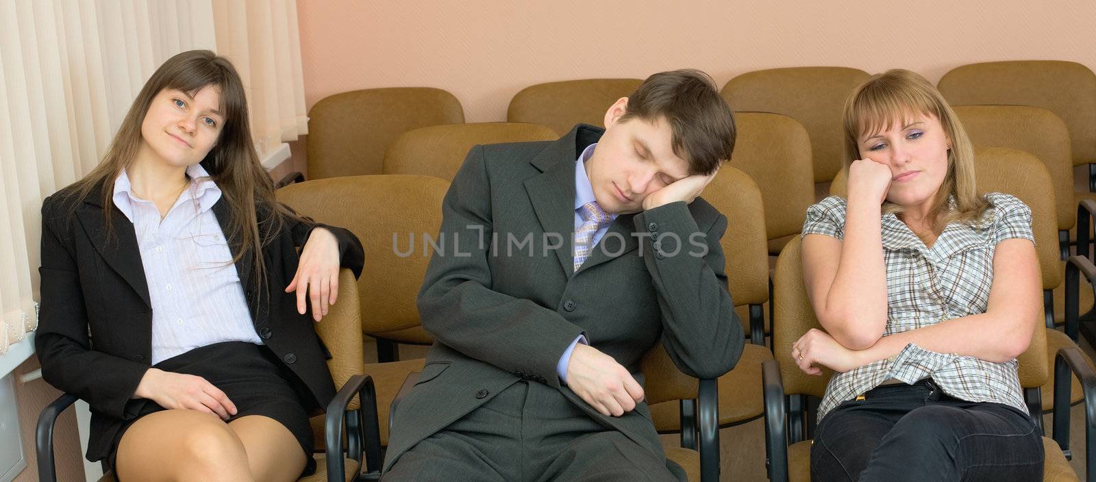 The young businessman has fallen asleep sitting at conference