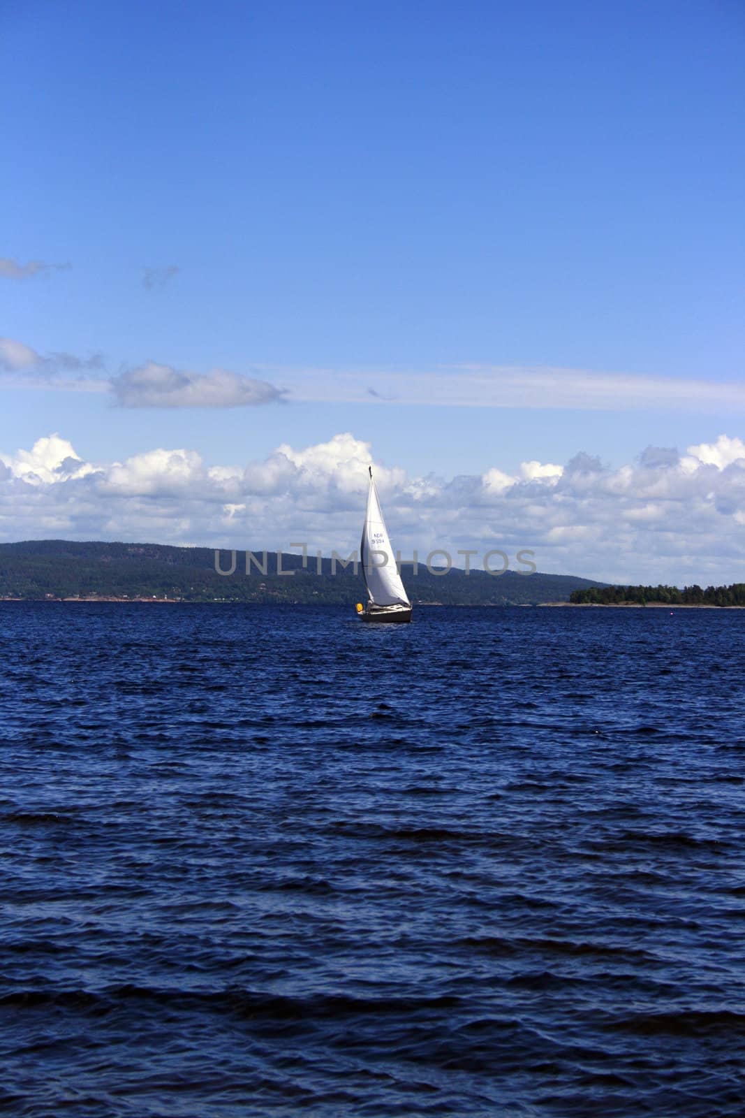 a sail boat nearing the harbour in Holmestrand, Norway.