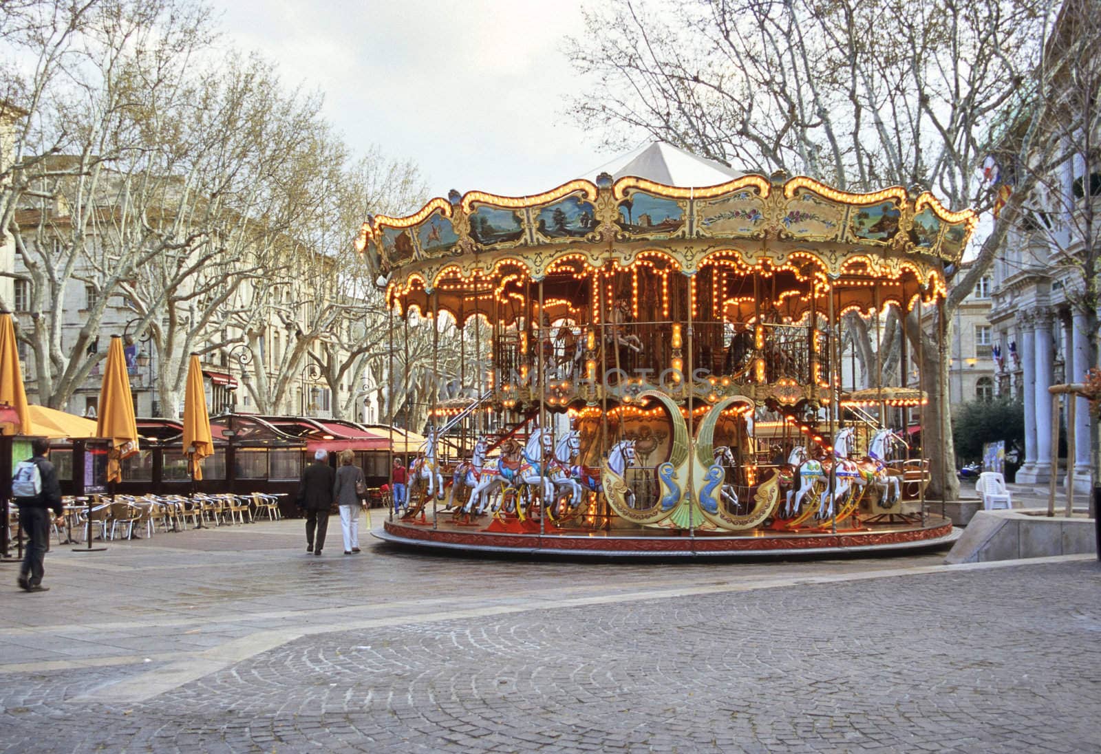 An old fashioned carousel sits in the middle of the square in Avignon, France.