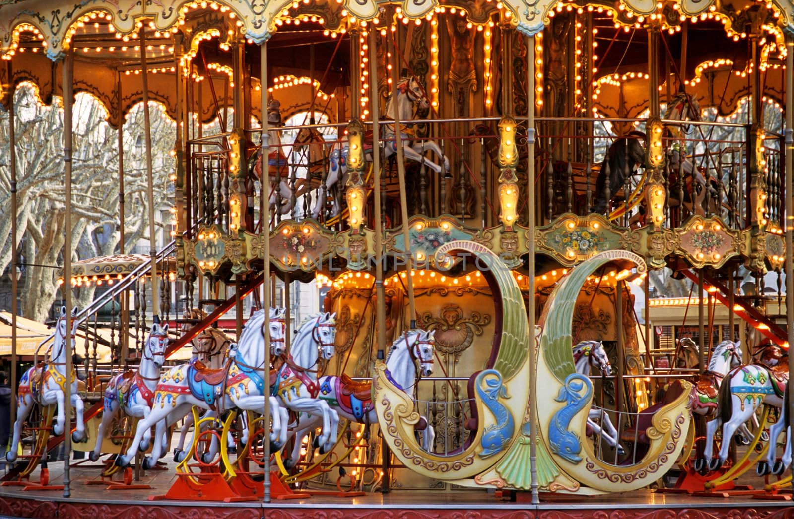 An illuminated antique Carousel awaits eager riders in the main square of Avignon, France.