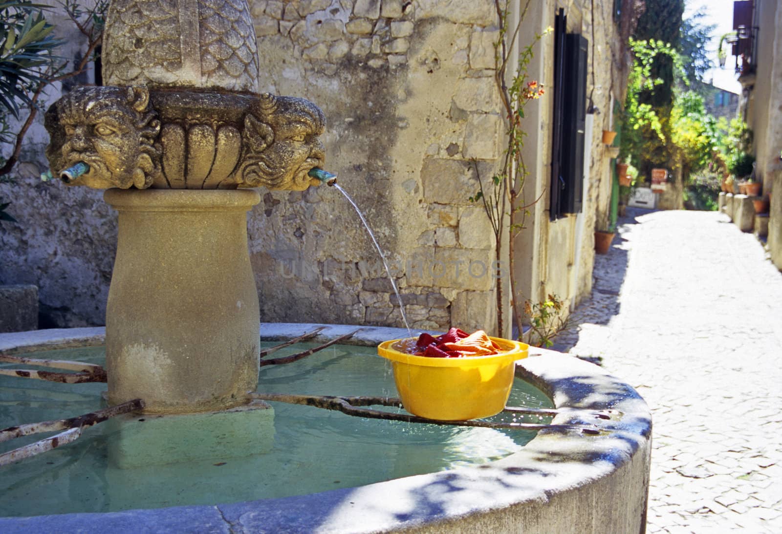 Laundry being washed in a fountain in a rural village in Provence.