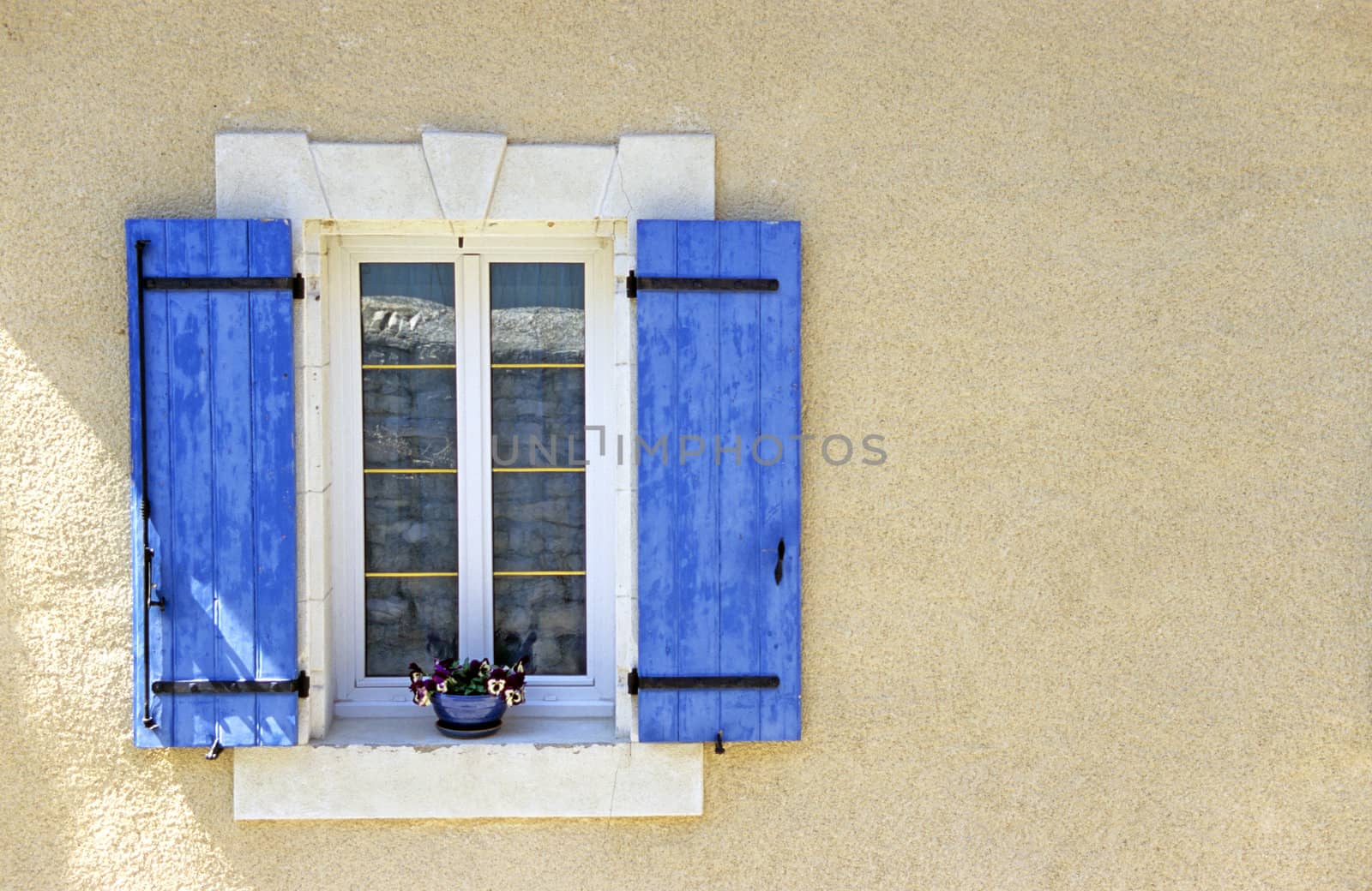 A Provencial window with the tradional blue shutters, Gigondas, France.