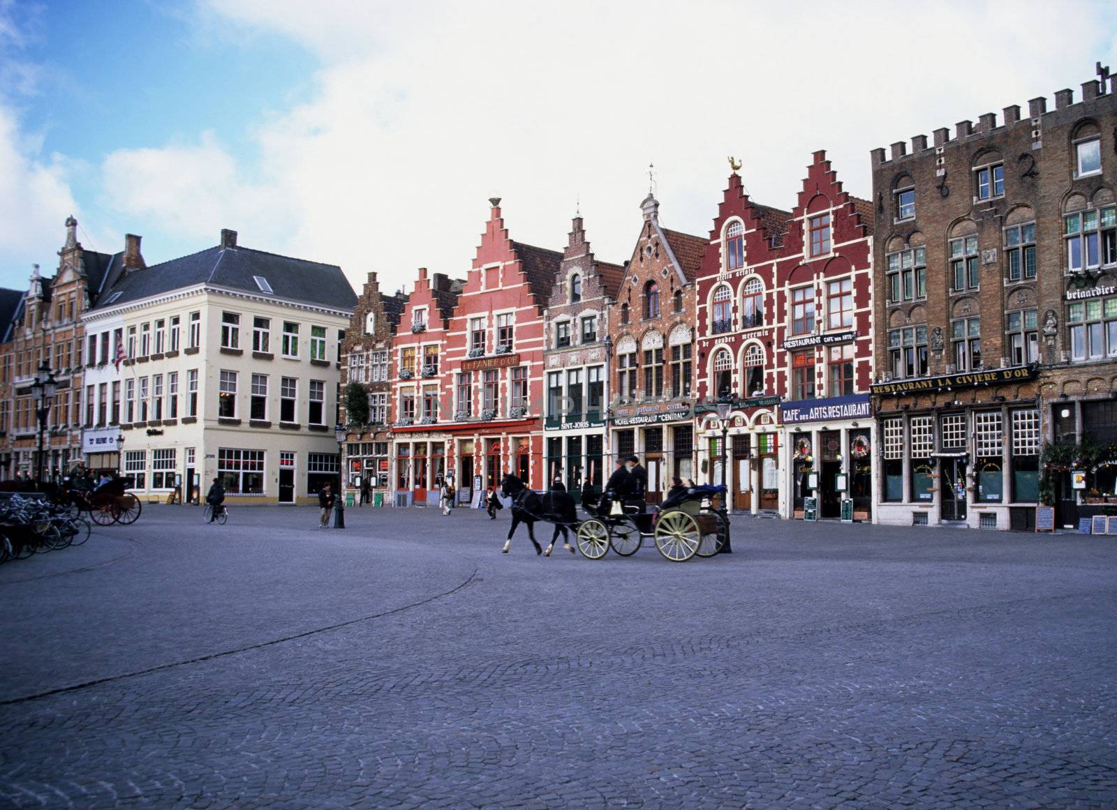 Colourful buildings of Brugges, Belgium with a horse drawn carriage.