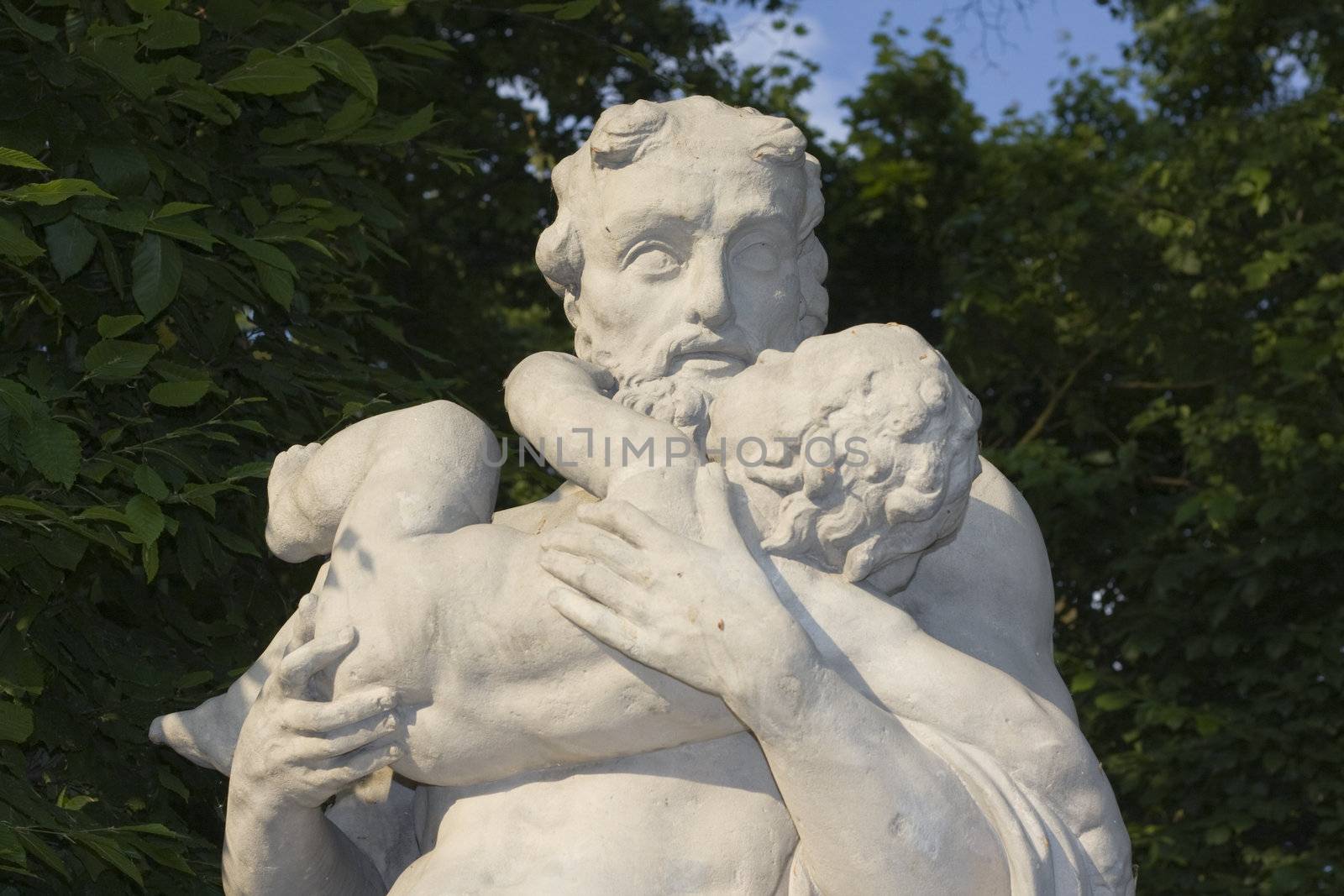 monument of an old man with a child on his hands