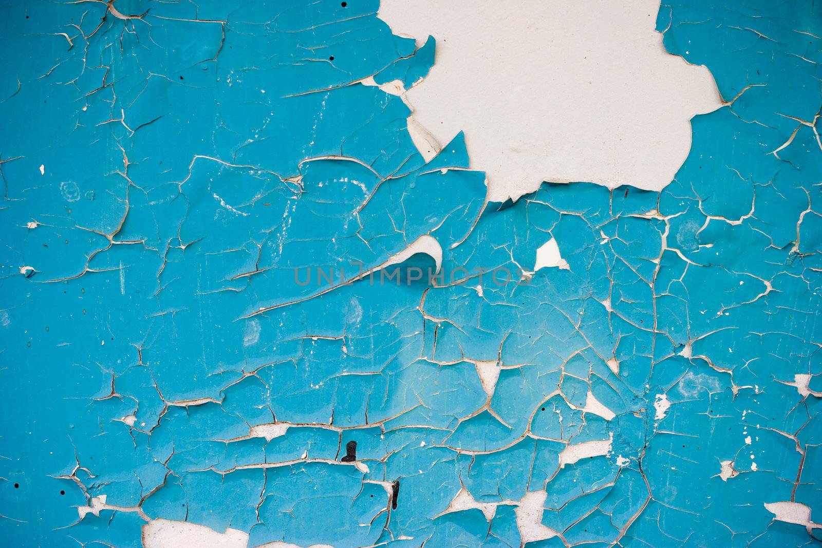 Blue peeling paint on the white wall grunge background