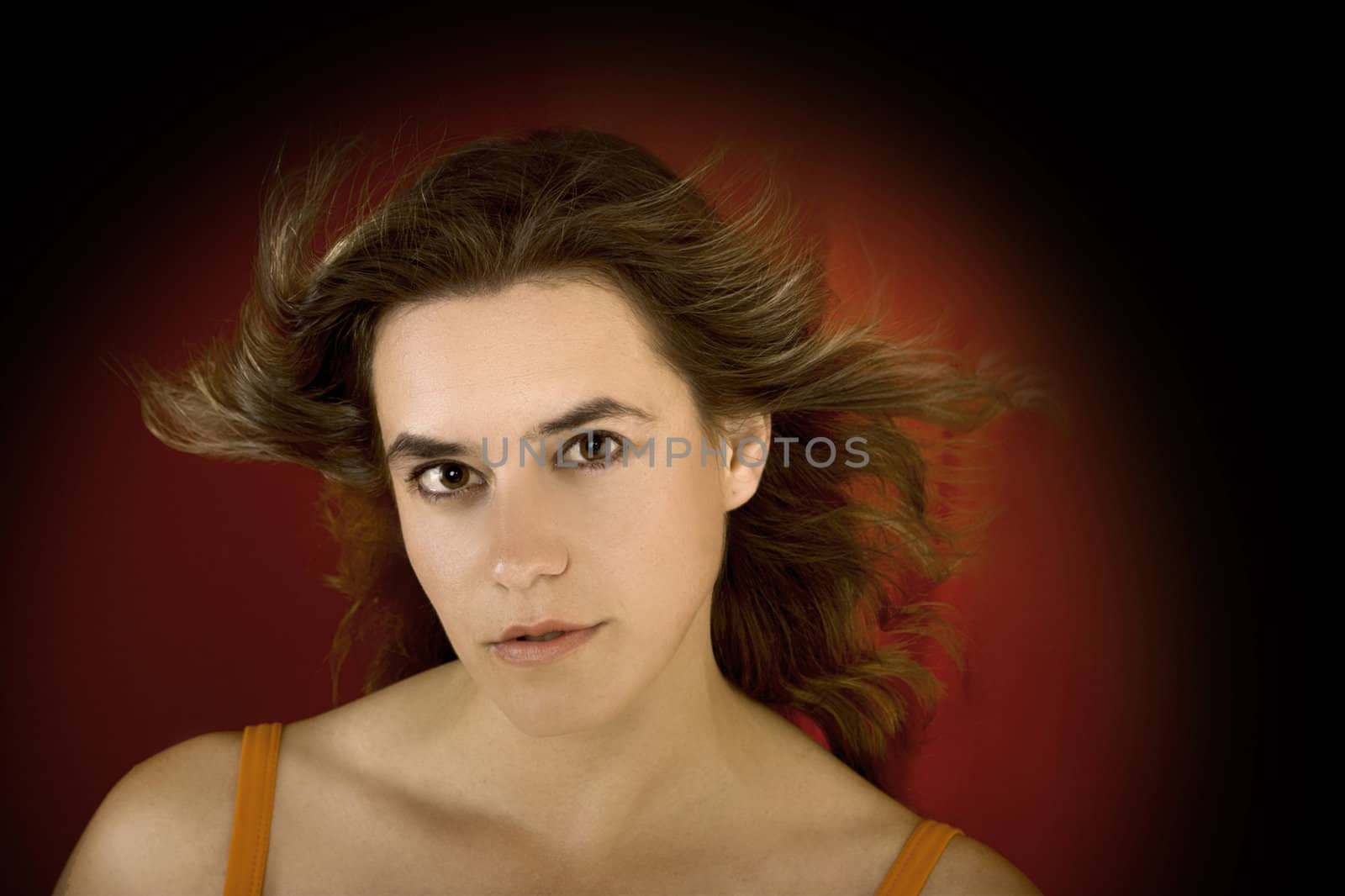 Young and beautiful woman portrait on a red background