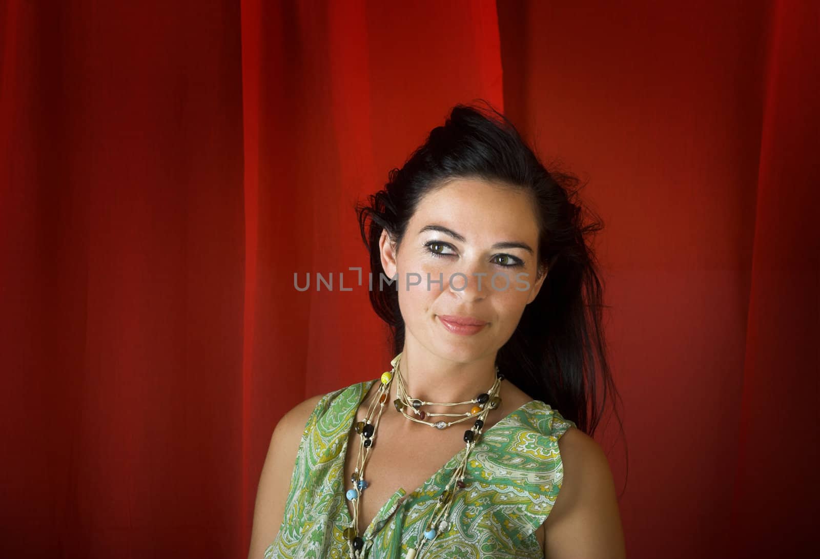 Young and beautiful woman portrait on a red background