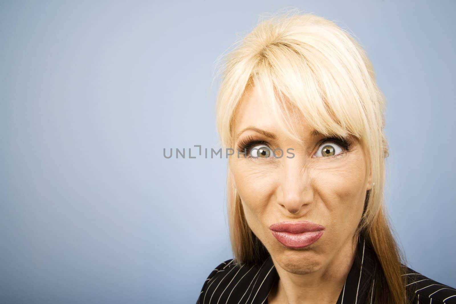 Businesswoman in a pinstripe suit making a funny face