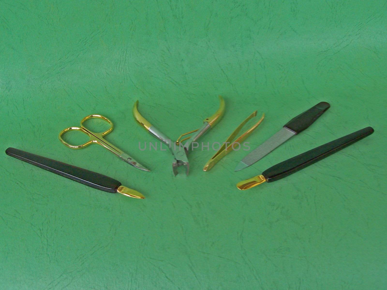 Several tools for hygiene. Close up. Green background.