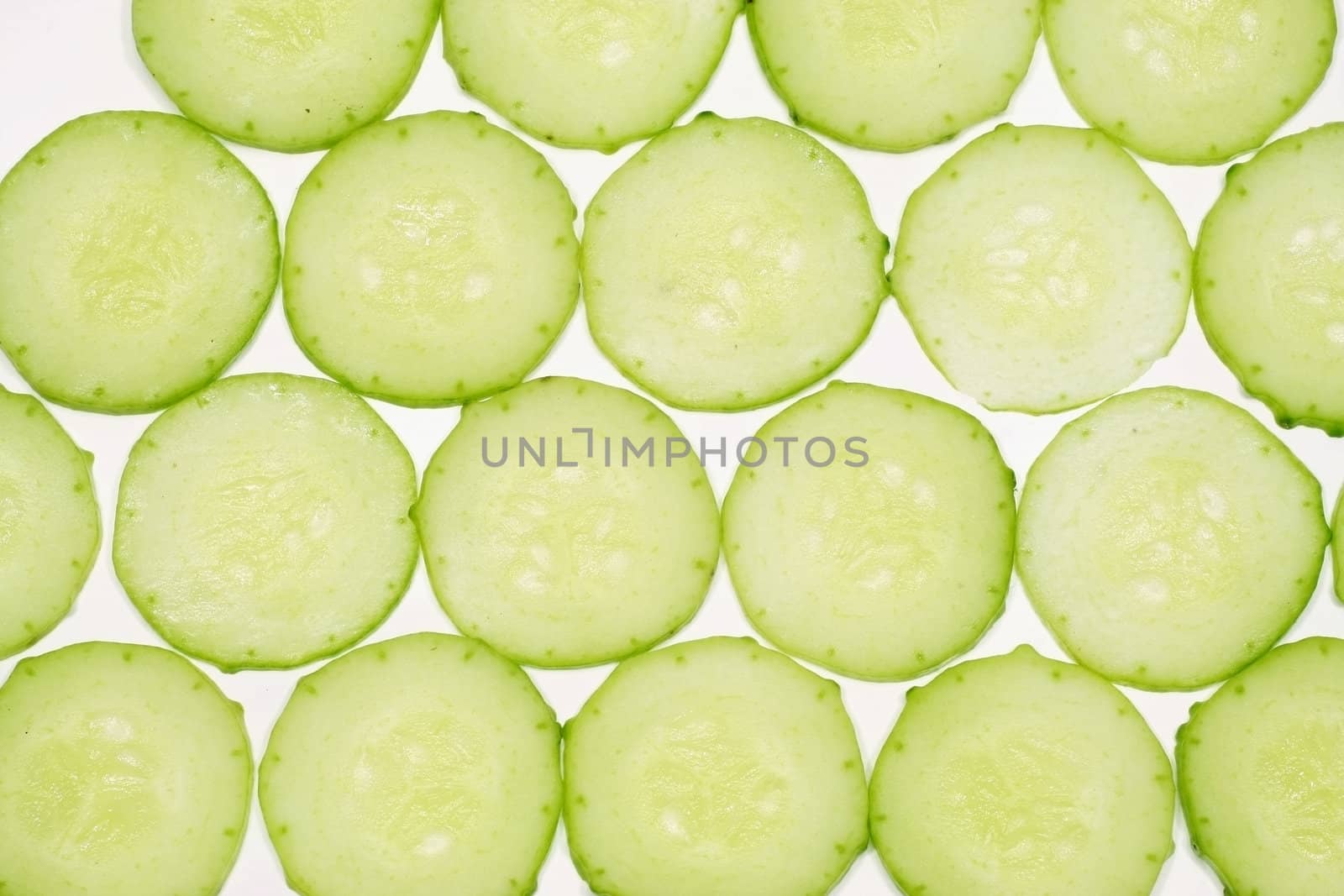 Thinly sliced cucumber on a white background